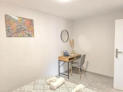 a bedroom with a desk with a chair and a mirror at Comfy flat with large terrace, Fiber internet and private parking in Chania Town