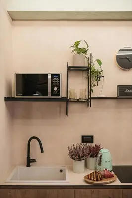 a kitchen with a sink and a microwave at Mimosa Minaret Jacuzzi Old Town Chania in Chania Town