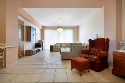 a living room with a couch and a chair at Purple Apartment Chania in Chania Town