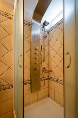 a bathroom with a shower with a glass door at Purple Apartment Chania in Chania Town