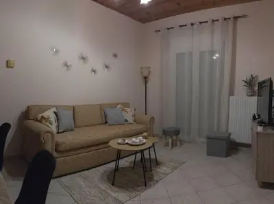 a living room with a couch and a table at Bayside Apt. in Souda