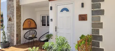 a door leading to a patio with plants at The Nook in Maleme