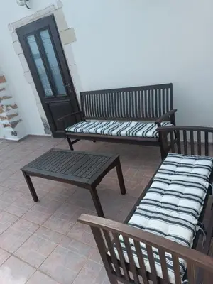 two benches sitting on a patio with a door at Villa Lina private pool in Kondomari