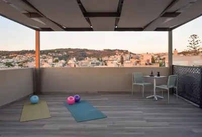 a room with two yoga mats on the floor with a table at Chania Elegance Suites in Chania Town