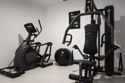 a gym with two exercise bikes and a helmet at Chania Elegance Suites in Chania Town