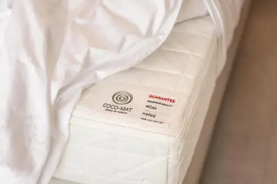 a white bed with a comforter on top of it at Chania Elegance Suites in Chania Town