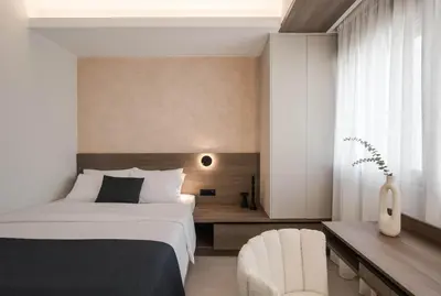 a bedroom with a bed and a chair and a desk at Chania Elegance Suites in Chania Town