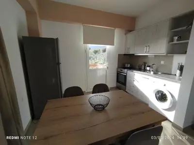 a kitchen with a wooden table with a bowl on it at Votsalo House in Khóra Sfakíon