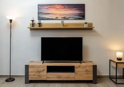 a flat screen tv sitting on top of a wooden entertainment center at Kyril Apartment in Chania Town
