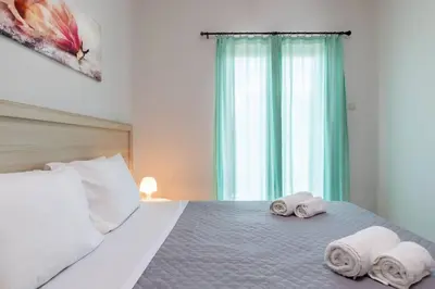 a bedroom with a bed with towels on it at Kyril Apartment in Chania Town