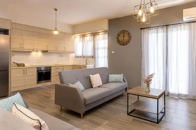 a living room with a couch and a table at Kyril Apartment in Chania Town