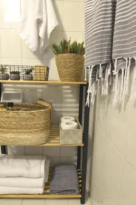 a bathroom with a shelf with towels and plants at Casa Vista in Kissamos