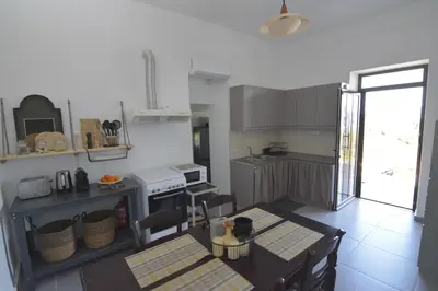 a kitchen with a table and a dining room at Casa Vista in Kissamos