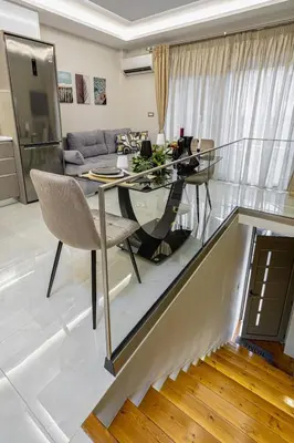 a glass table and chairs in a living room at Nicole Studio in Center Chania in Chania Town