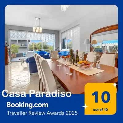 a dining room and living room with a table and chairs at CasaParadiso in Perivólia