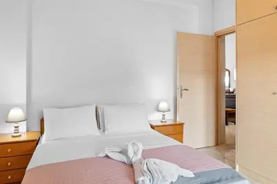 a bedroom with a bed with two feet on it at CasaParadiso in Perivólia