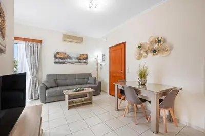 a living room with a table and a couch at Sofie's Garden View Apartment in Daratso