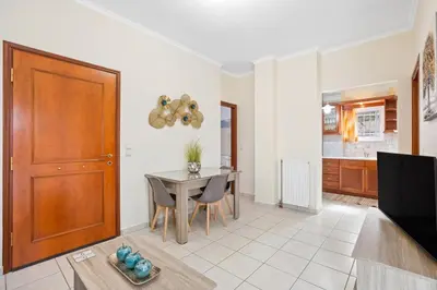 a living room with a table and a dining room at Sofie's Garden View Apartment in Daratso
