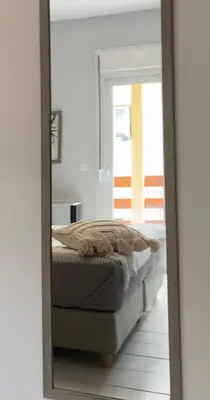a mirror reflecting a bed in a bedroom at NICOL's HOUSE in Chania Town