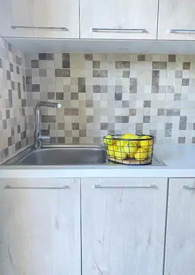 a kitchen sink with a basket of bananas in it at NICOL's HOUSE in Chania Town