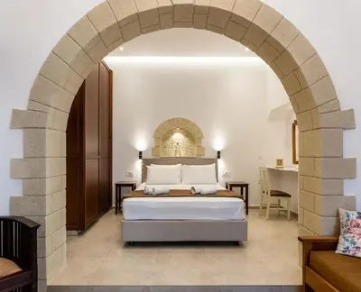 a bedroom with a bed and an archway at The Owl House near Chania City Centre in Chania Town