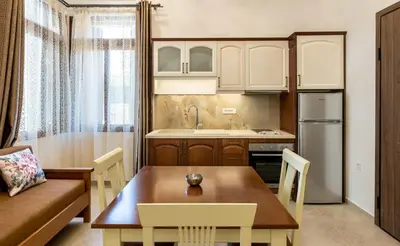 a kitchen with a table and a couch and a dining room at The Owl House near Chania City Centre in Chania Town