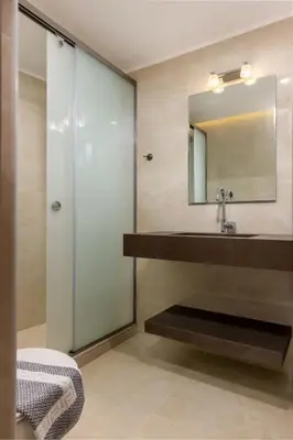 a bathroom with a sink and a mirror at The Owl House near Chania City Centre in Chania Town