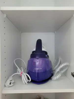 a purple tea pot sitting on a shelf at Cretan Dream in Chania Town