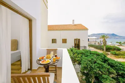 a balcony with a table with plates of food on it at Kissamos Bay Hotel in Kissamos