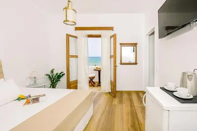 a white kitchen with a view of the ocean at Kissamos Bay Hotel in Kissamos