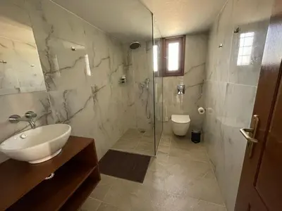 a bathroom with a shower and a sink and a toilet at Kissamos Bay Hotel in Kissamos