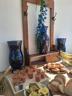 a table topped with plates of food and vases at Kissamos Bay Hotel in Kissamos