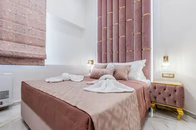 a bedroom with a large bed with towels on it at Kallisti Palace - Private Pool with Hydromassage in Kissamos