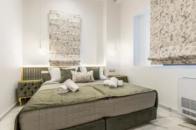 a bedroom with a large bed with two pillows on it at Kallisti Palace - Private Pool with Hydromassage in Kissamos
