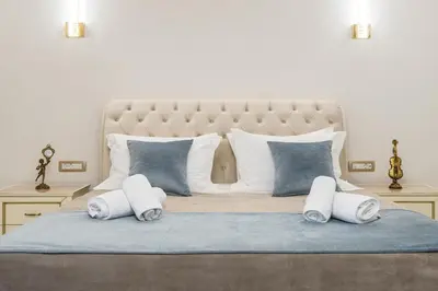 a bedroom with a large bed with white and blue pillows at Kallisti Palace - Private Pool with Hydromassage in Kissamos