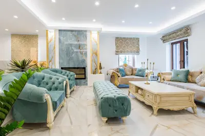 a living room with blue furniture and a fireplace at Kallisti Palace - Private Pool with Hydromassage in Kissamos