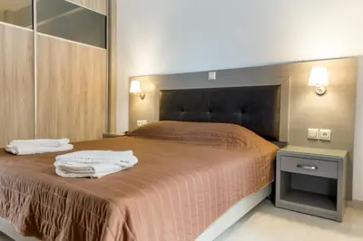 a bedroom with a bed with two towels on it at Angela Apartments in Kato Daratso
