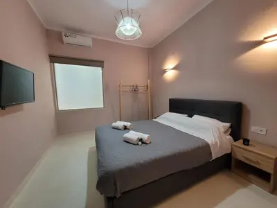 a bedroom with two towels on a bed at Friday's House in Chania Town