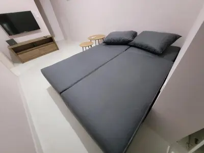 a large bed in a room with a tv at Friday's House in Chania Town