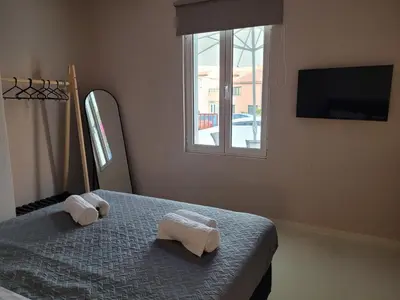a bedroom with two towels on a bed with a window at Friday's House in Chania Town