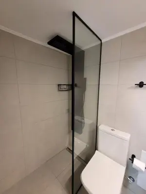 a bathroom with a toilet and a glass shower at Friday's House in Chania Town