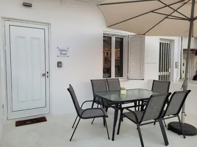 a dining room with a black table and chairs at Friday's House in Chania Town