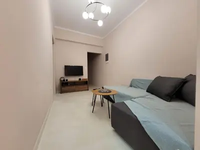 a living room with a bed and a table at Friday's House in Chania Town
