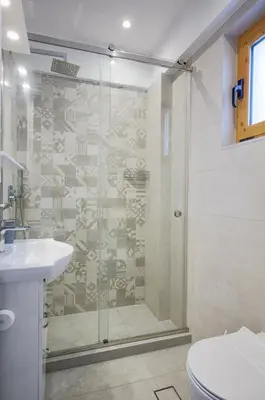 a bathroom with a shower and a toilet and a sink at Aspro Apartments in Koprána