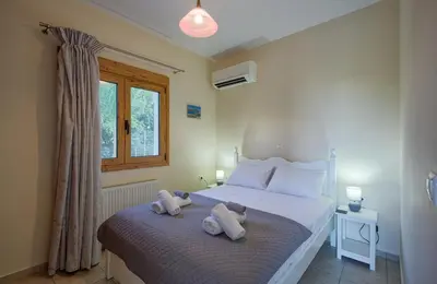 a bedroom with a bed with towels on it at Aspro Apartments in Koprána