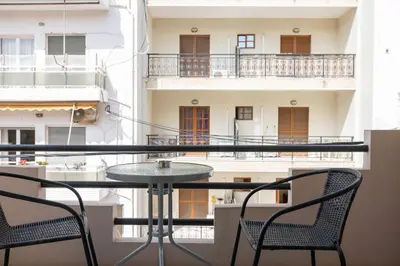 a table and chairs on a balcony with a view of a building at Dimitris City Break Apts in Chania Town