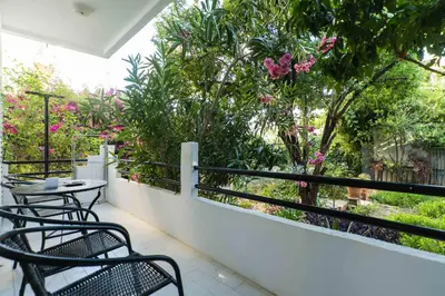 a balcony with two chairs and a table and flowers at Dimitris City Break Apts in Chania Town
