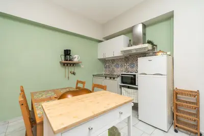 a kitchen with a white refrigerator and a table at Dimitris City Break Apts in Chania Town