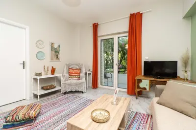 a living room with a couch and a tv at Dimitris City Break Apts in Chania Town