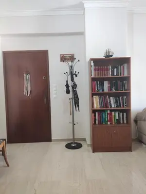 a room with a book shelf and a door with books at Georgia apartment in Chania Town